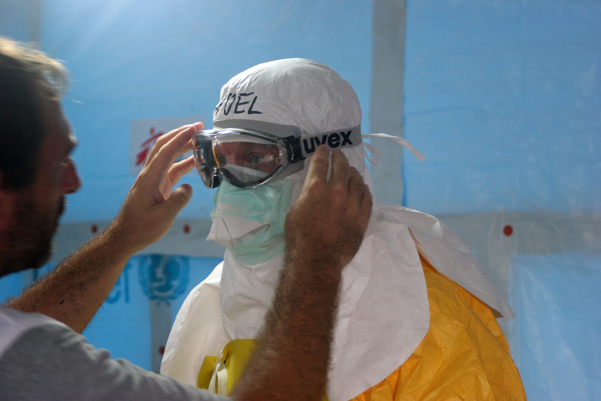 Health workers prepare to enter an Ebola treatment unit Health workers in protective suits preparing to enter an Ebola treatment unit