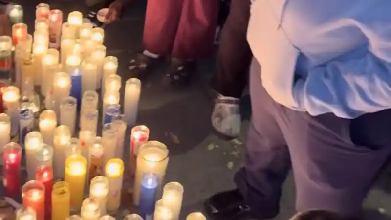 Candles lit on the pavement at a vigil for 15-year-old Javits Frimpong in the Bronx